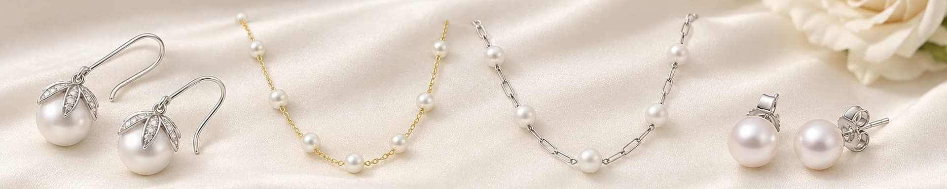Pearl drop earrings, station necklaces and studs on ivory silk